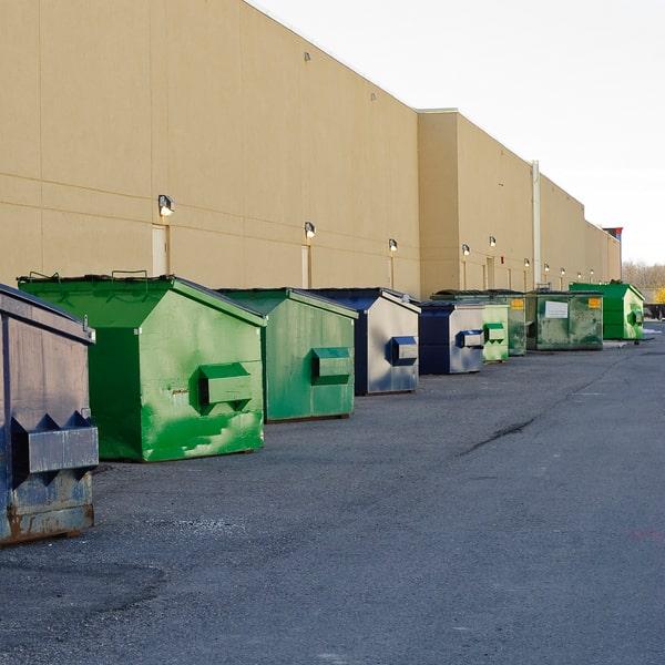 commercial dumpster sitting in a parking lot